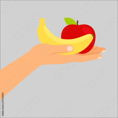 Hand holding banana and apple