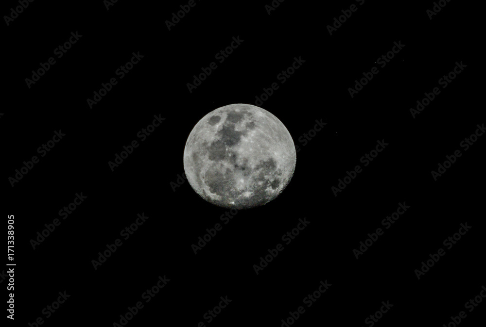 Close up of full moon over black sky. Black and white. Close up of full moon over black sky. Black and white.
