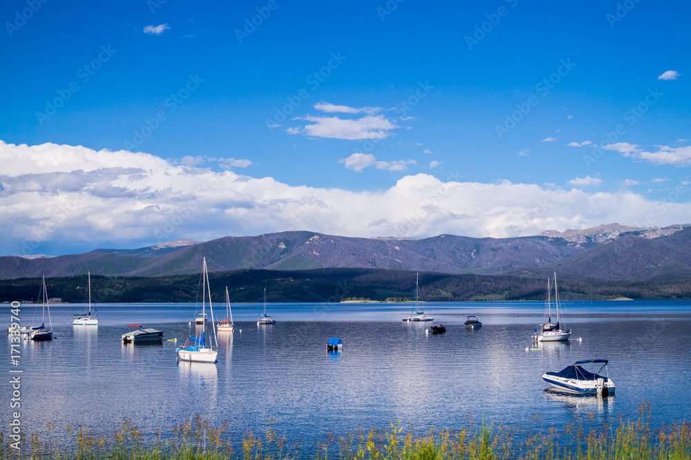 Fototapeta premium White yachts, blue sky and blue clear water Grand Lake. Fishing in the rocky mountains
