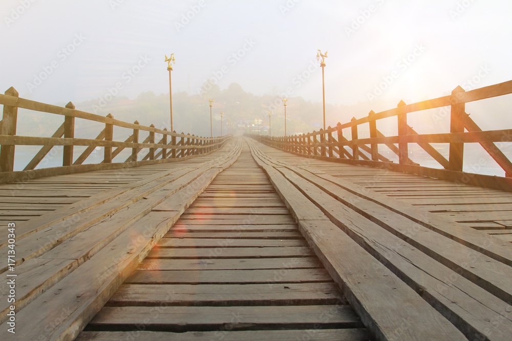 holiday and travel,landscape perspective wood bridge old with mist and sunrise in morning time