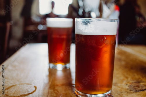 An english ale bitter beer pint on a wooden table in a pub in UK