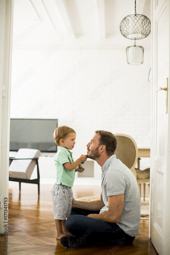 Happy father with his son playing at home