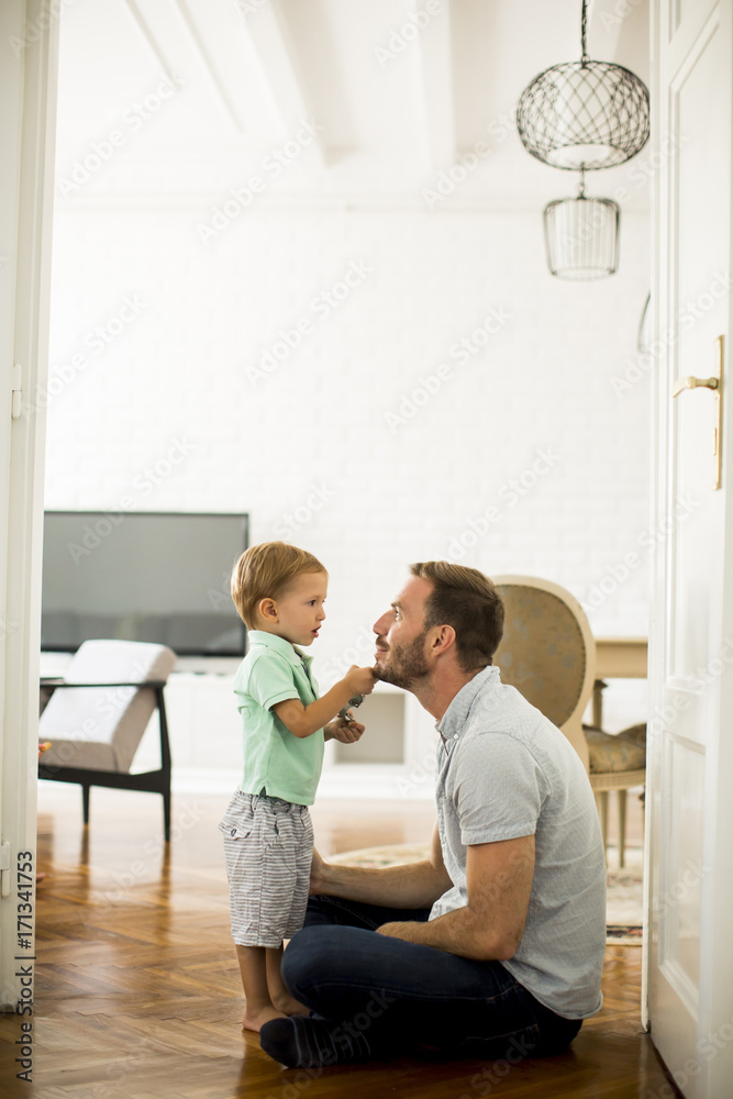 Happy father with his son playing at home Happy father with his son playing at home
