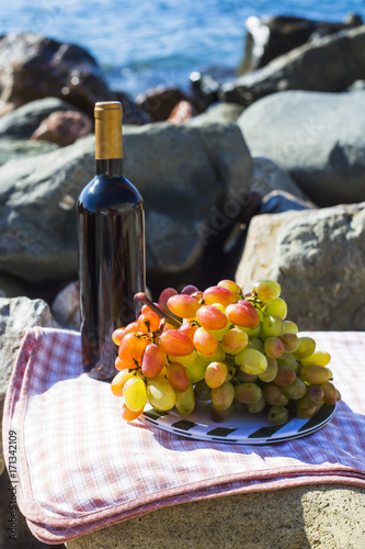 autumn picnic by the sea with wine and fruit
