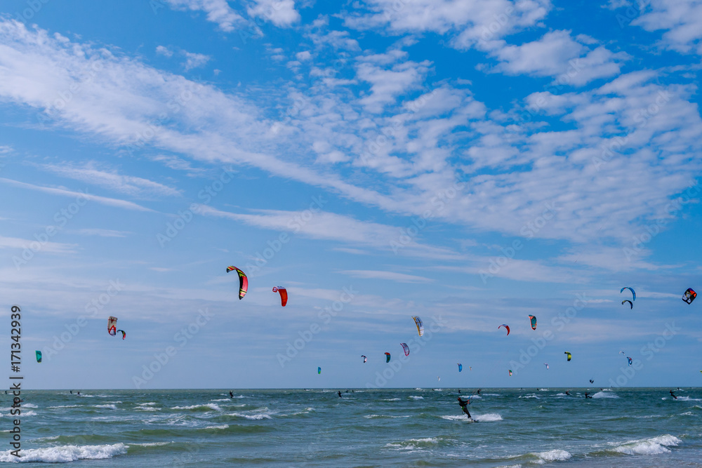 many kite surfers on the sea