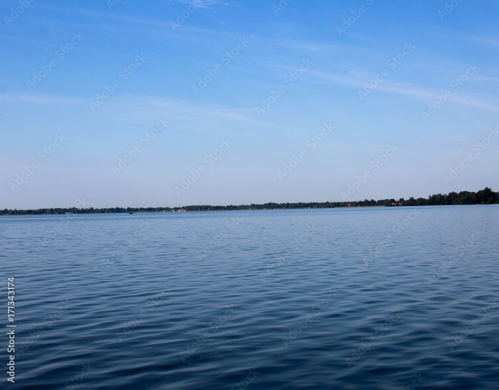 The blue looking lake and the blue sky background.