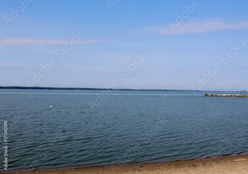 The view of the lake from the sand of the beach.