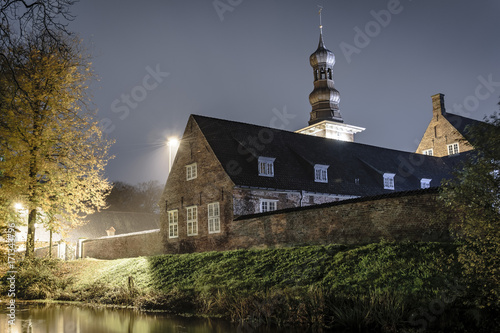 Church next to the lake during the next. Husum, Germany photo