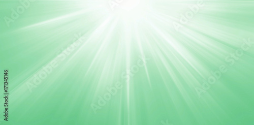 Light sun rays on a green background, radiant green summer banner.