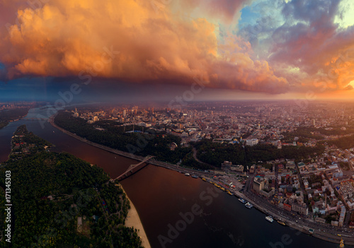 Beautiful panorama of the city of Kiev from the air. The Dnieper River and the two banks of the city at sunset. Trukhanov Island and Footbridge.