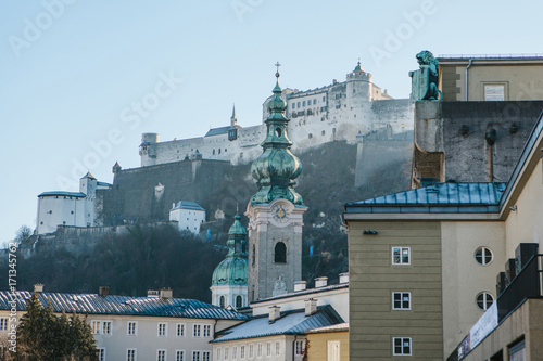 Nonnberg abbey in Salzburg in Austria. One of the attractions of the city and a favorite place for visiting tourists. In the background is the fortress of Hohensalzburg. Sight. photo