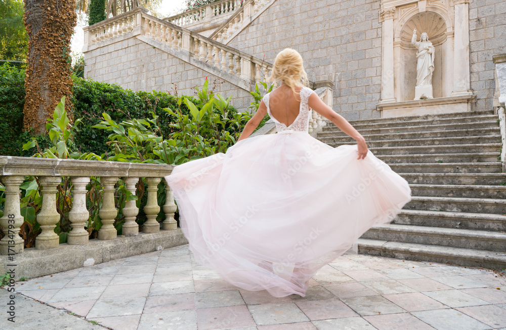 Fototapeta premium bride in a dress is spinning in a dance