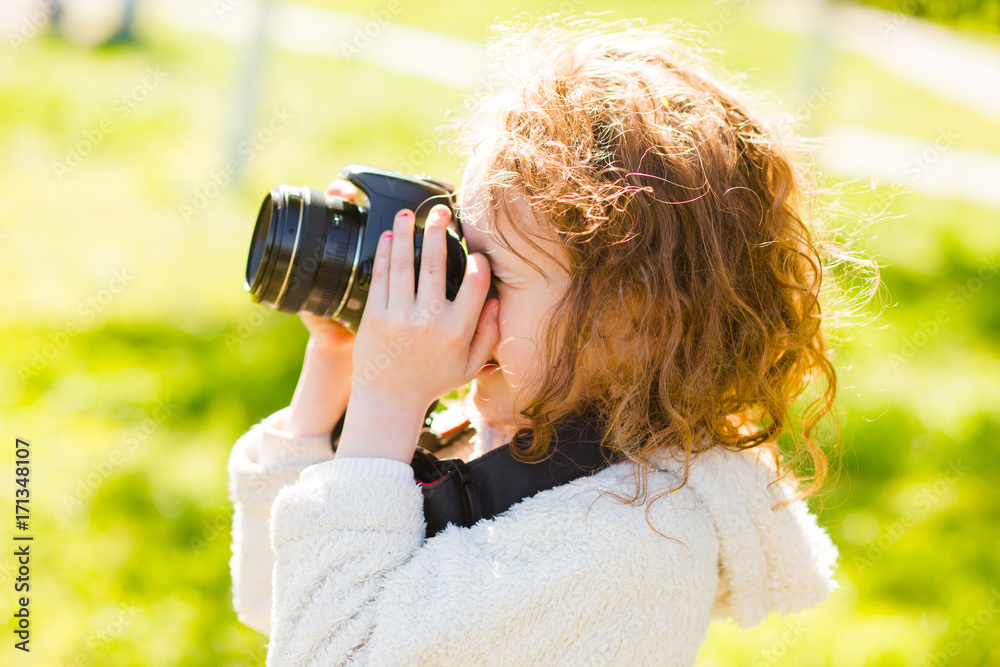 Little girl is taking pictures. Camera is in child's hands. Little girl is taking pictures. Camera is in child's hands.