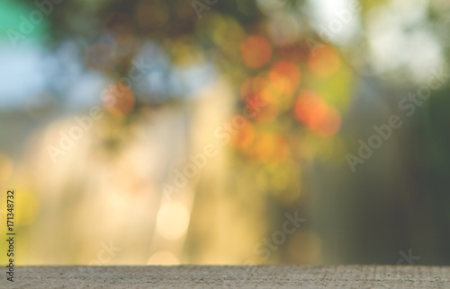 wood table over blurred trees with bokeh background