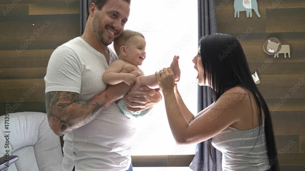 baby with mother and father in the room