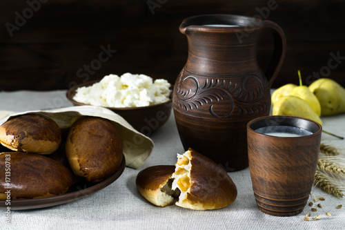 Milk, cottage cheese, pies in earthenware, pears