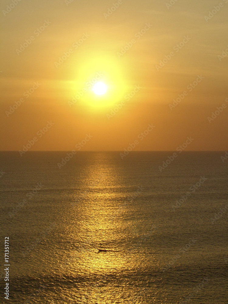 Fototapeta premium a fishing boat sails at the coast of Bali to home