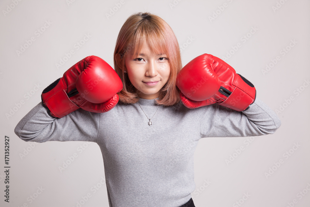 Young Asian woman with red boxing gloves. Young Asian woman with red boxing gloves.