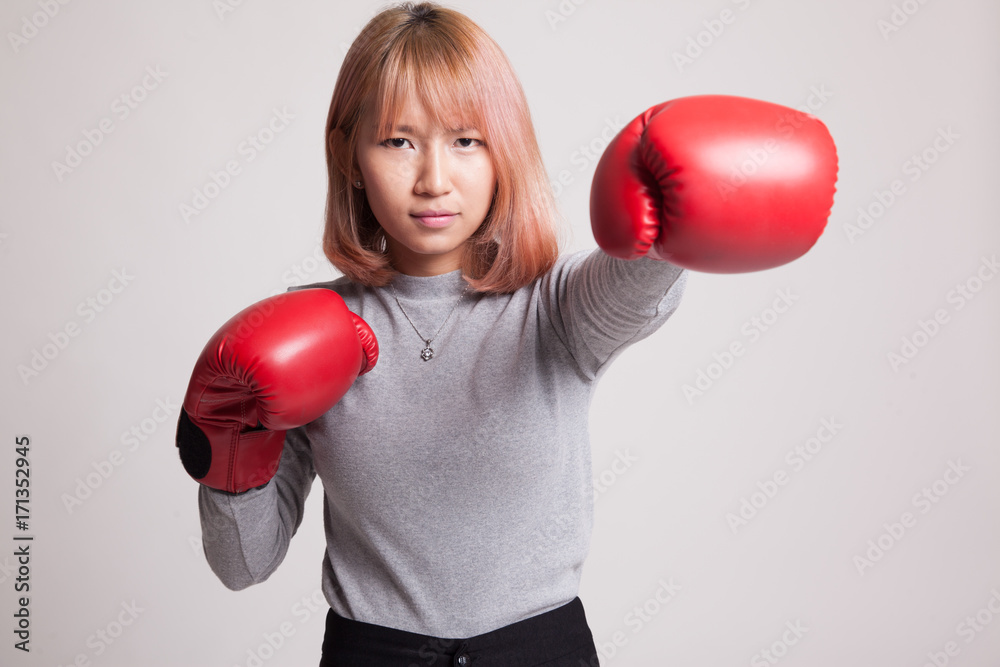 Young Asian woman with red boxing gloves. Young Asian woman with red boxing gloves.