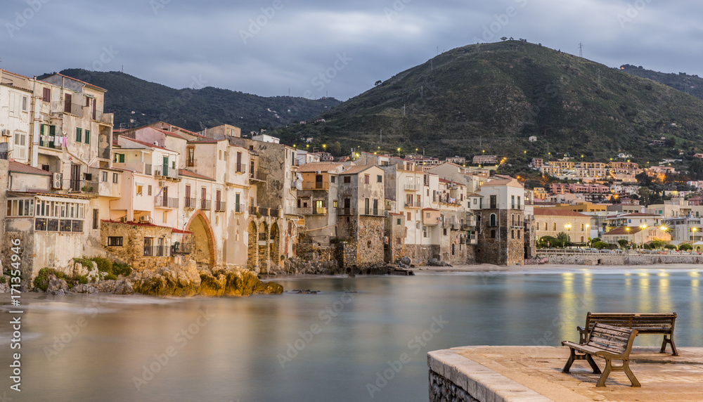 Beautiful harbor view of old houses in Cefalu at dusk, Sicily