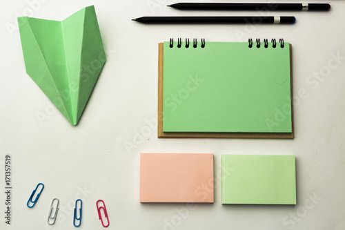 Modern samples of stationery, notebooks, stickers and pencils.