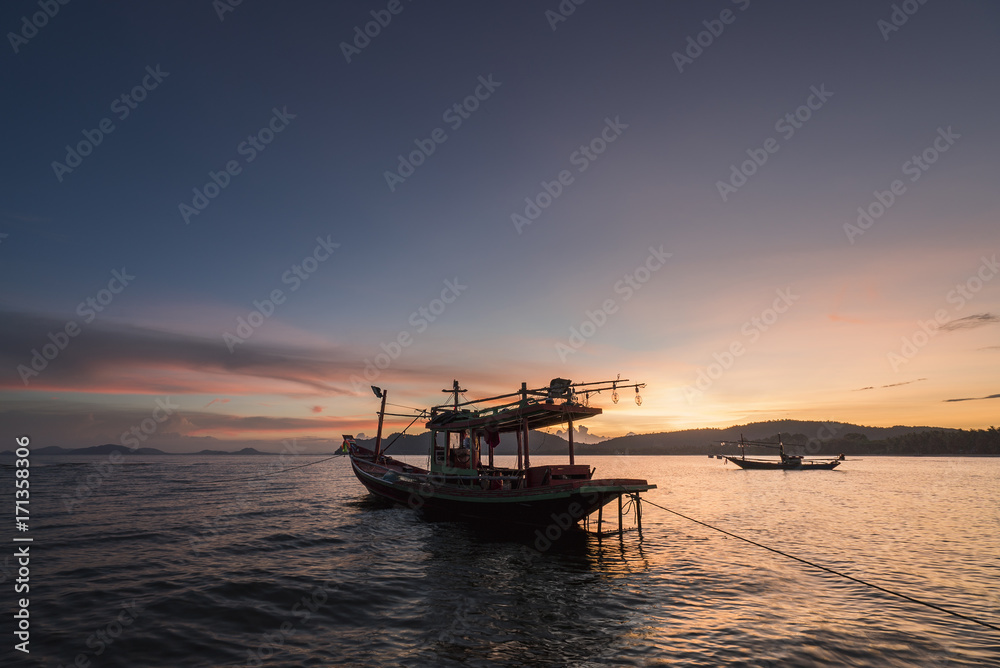 Thai taxi boat at sunset in Andaman sea Thailand.