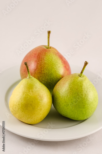 Ripe pears on the white background