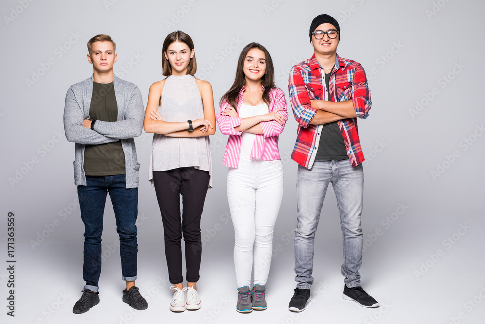 Happy smiling young group of friends standing together isolated on white Happy smiling young group of friends standing together isolated on white
