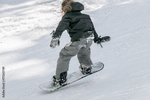 boy jumping on a snowboard at a ski resort 