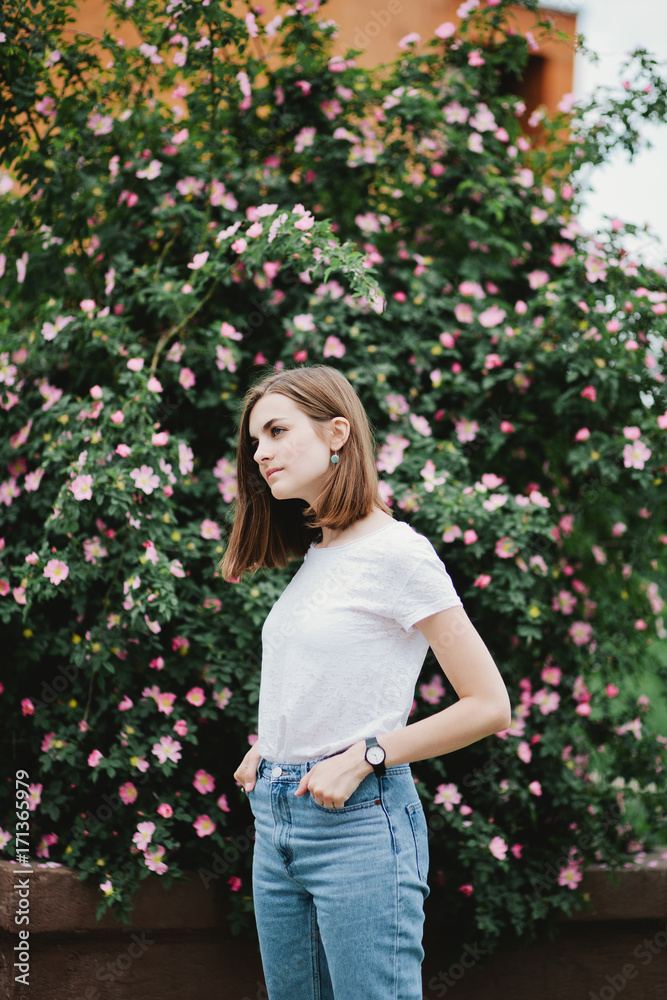 Portrait of a pretty girl standing in spring blossom park Portrait of a pretty girl standing in spring blossom park