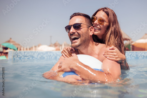 Couple in the swimming pool © ivanko80