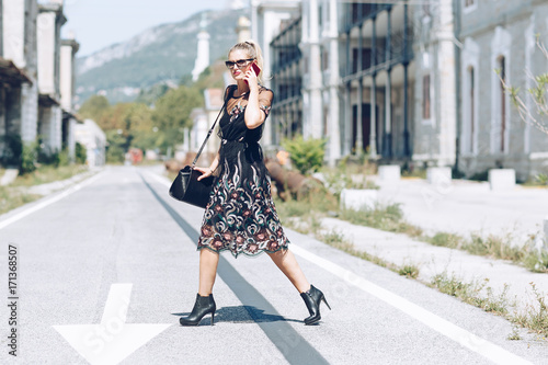 Young business woman with handbag running to catch the plane or train. Elegant trendy clothing. Hurrying to work concept.