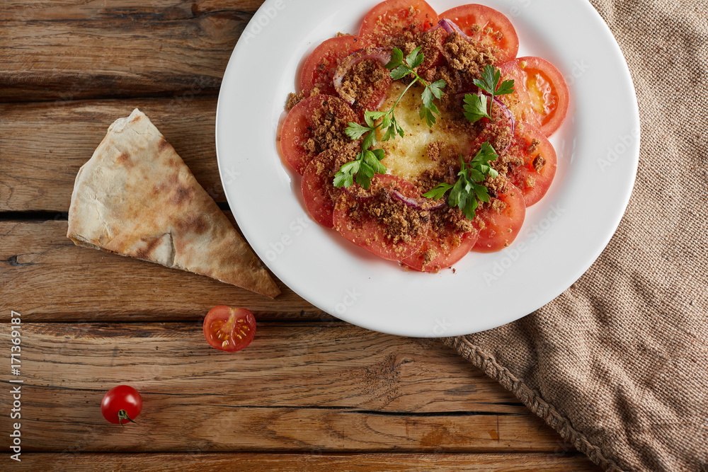Fried dish of tomato, parsley, eggs and cheese inside. Fried dish of tomato, parsley, eggs and cheese inside.