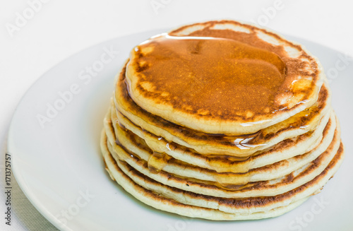 American pancakes with honey against white background