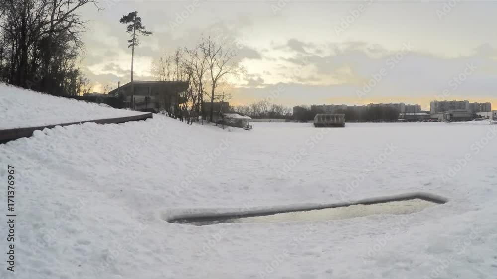 icehole on the pond in winter evening timelapse icehole on the pond in winter evening timelapse