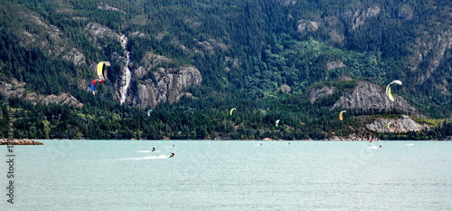 Kiteboarding. Fun in the ocean. Extreme Sport Kite surfing. Kite surfers On the background of mountain hill and Shannon Falls.