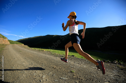 young fitness woman runner running on mountain trail © lzf