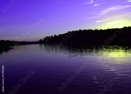 Blue Lake Sunset/Blue and Yellow Sunset reflection on a lake. © bodnarinq
