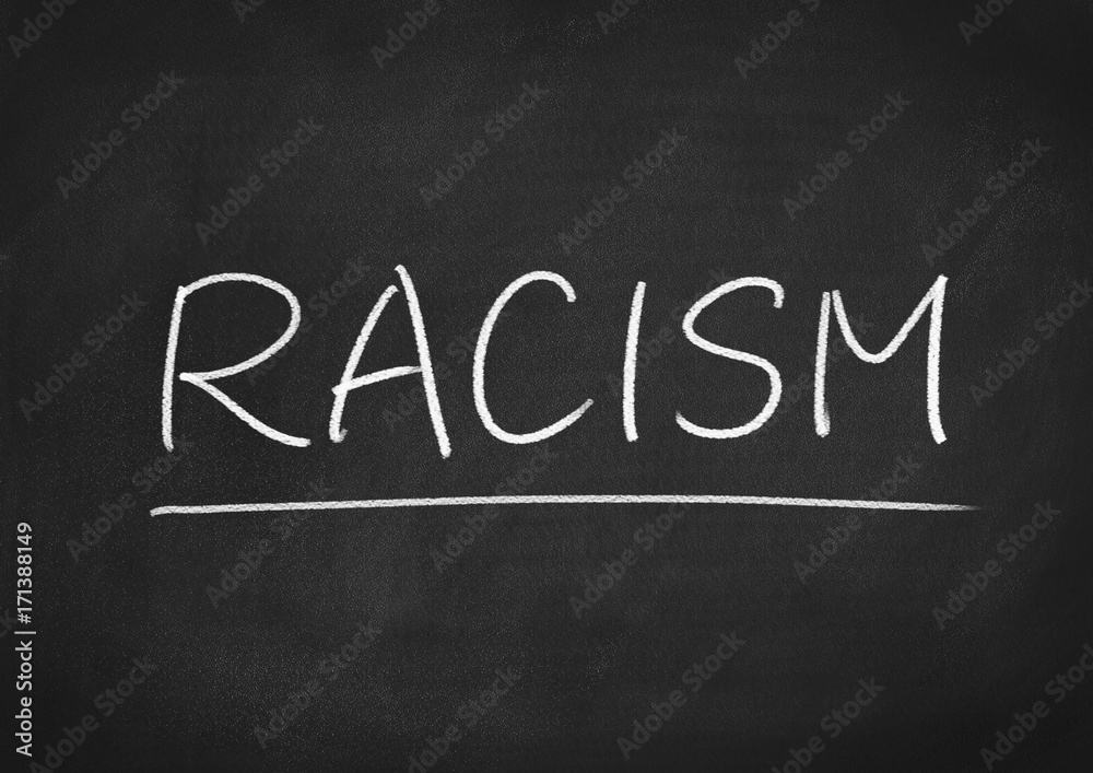 racism concept word on a blackboard background racism concept word on a blackboard background