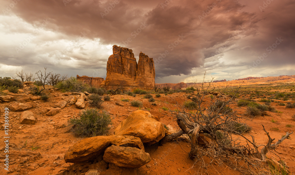 Dramatic storm clouds in Arches National Park and red sandstone formations