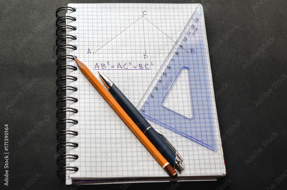 Page with formulas and the Pythagorean theorem with pen, pencil and ruler Page with formulas and the Pythagorean theorem with pen, pencil and ruler