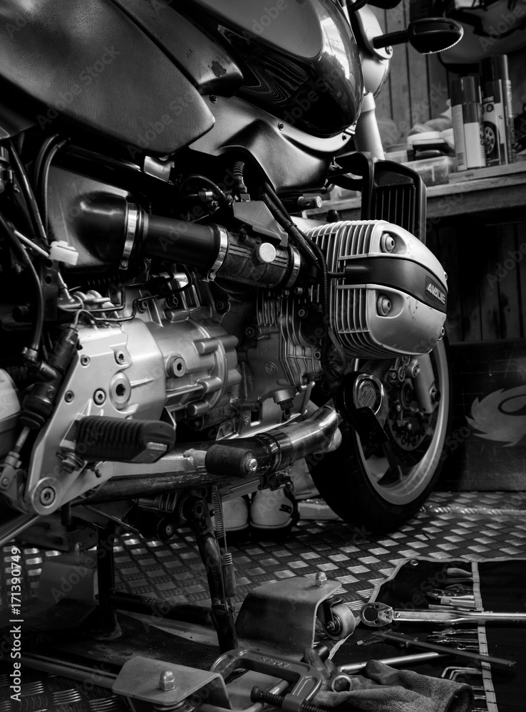 CHONBURI, THAILAND- SEPTEMBER 10, 2017 :Tool on the platform and single cylinder head cover in motorcycle shop,black and white scene, black and white image