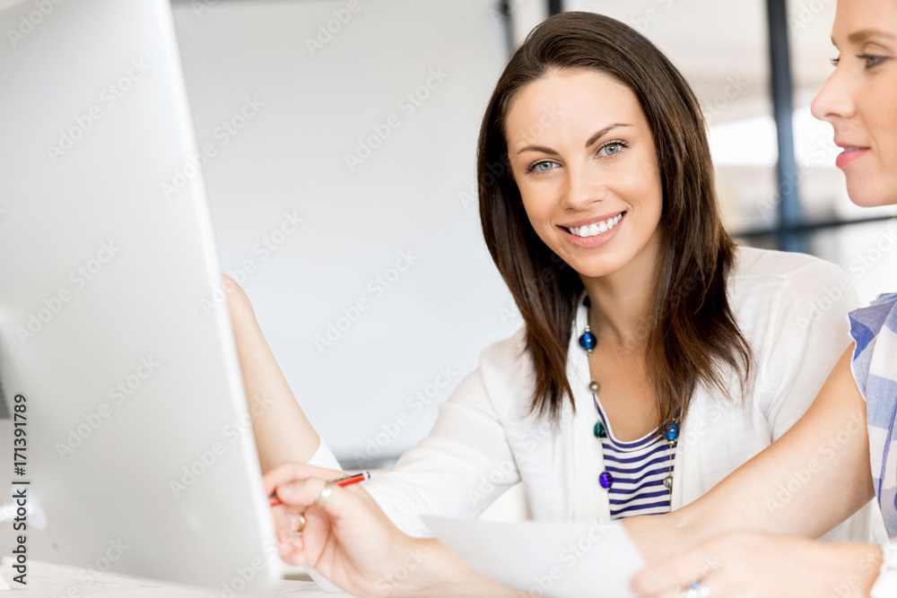 Image of two young business women in office Image of two young business women in office