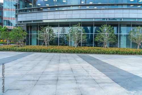 empty pavement and modern buildings in city.