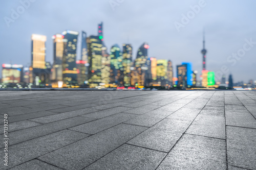 cityscape and skyline of shanghai from empty square at dusk