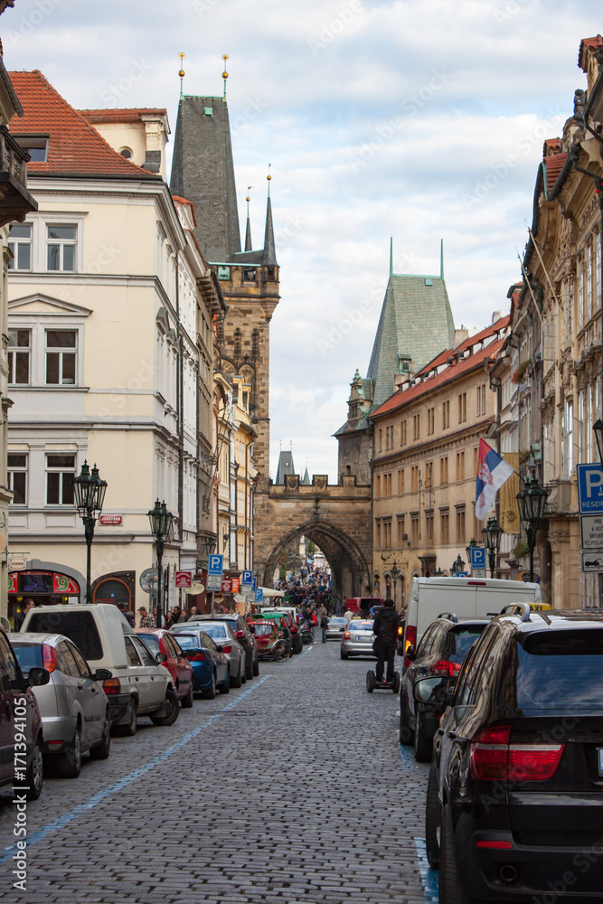 Obraz premium Cobblestone Street in Prague With Cars on Both Sides