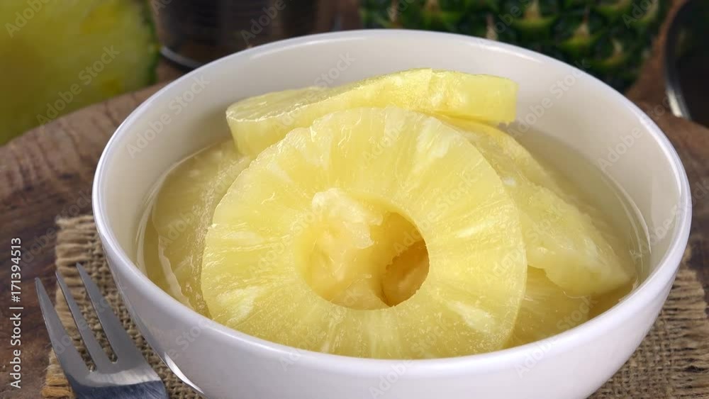 Portion of Preserved Pineapple pieces rotating on a wooden plate (not loopale; 4K) Portion of Preserved Pineapple pieces rotating on a wooden plate (not loopale; 4K)