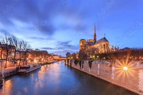 Notre dame in Paris (Our Lady of Paris) at twilight. It is a medieval Catholic cathedral, considered to be one of the finest examples of French Gothic architecture. View from the River Seine. France.