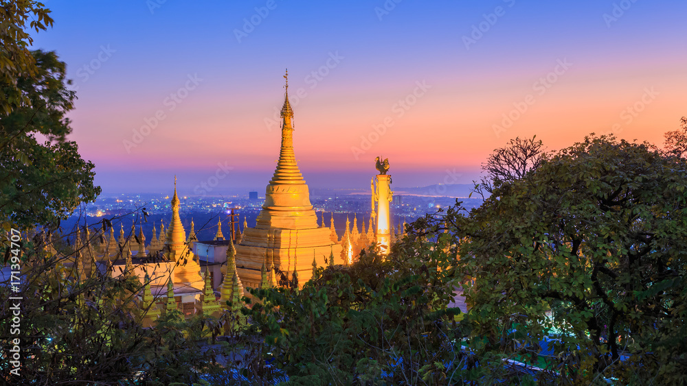 Golden stupas on Sagaing hill Sagaing City and Mountains surrounded by trees st twilight or sunset , The Old City of Religion and Culture and land of pagoda Mandalay Myanmar Burma