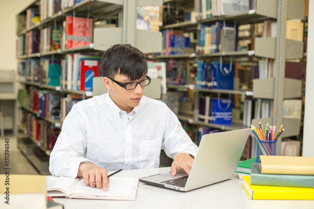 Student using Laptop for Research Information at library, People with Education concept. Student using Laptop for Research Information at library, People with Education concept.